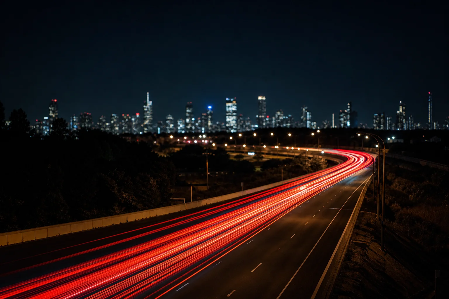 Long exposure of car taillights creating a rising graph shape